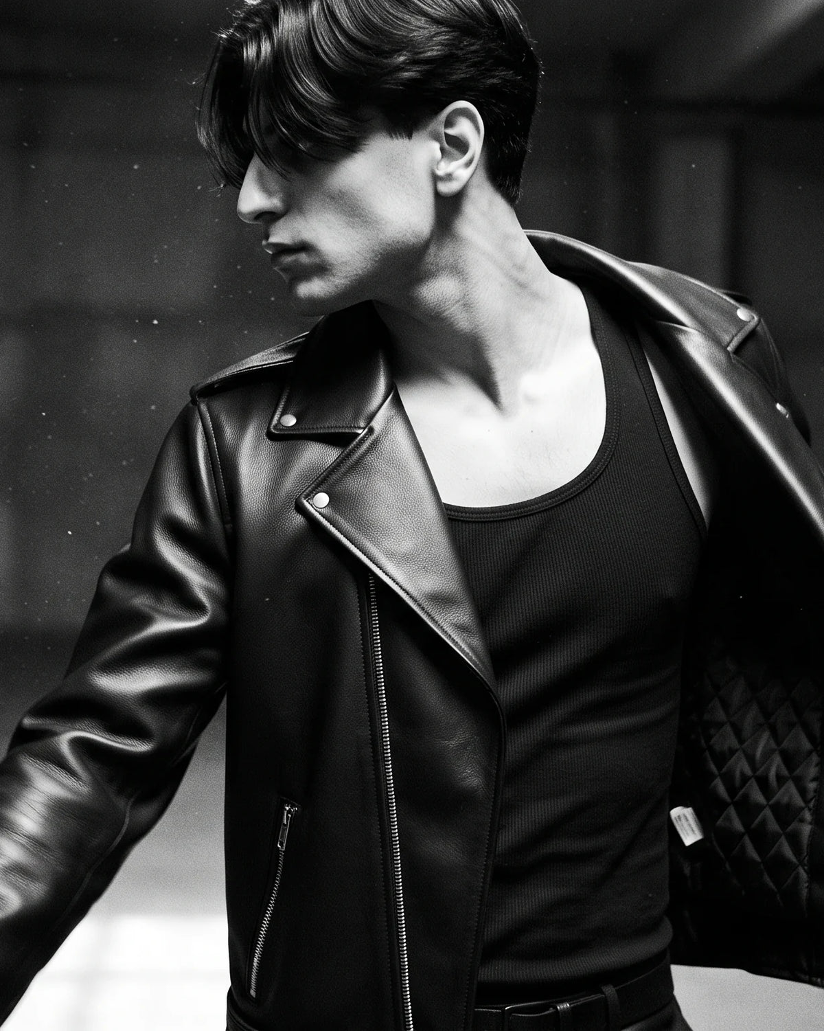 Zaryash black faux leather biker jacket, in motion, showing the quilted lining