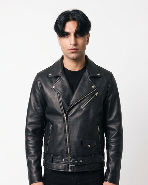 Zaryash black faux leather biker jacket, front view with asymmetric zip, studded lapels and belt